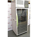 A side-angled view of the tall, upright Caron 7000-33-1 environmental chamber, showcasing the unit's side profile, full-length glass door with a bright green handle, and top-mounted control interface, all positioned in front of an American Instrument Exchange backdrop.
