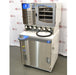A side-angled view of the Labconco FreeZone 6-liter freeze dryer system and its attached stoppering tray dryer, highlighting the unit's stainless steel finish, drying ports, and control interface against an American Instrument Exchange backdrop.