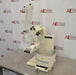 An angled side-front view of a Buchi R-300 rotary evaporator system resting on a stainless steel laboratory benchtop in front of an American Instrument Exchange backdrop, displaying the heating bath, lift arm, drive unit, glass condenser assembly, and attached receiving flask.