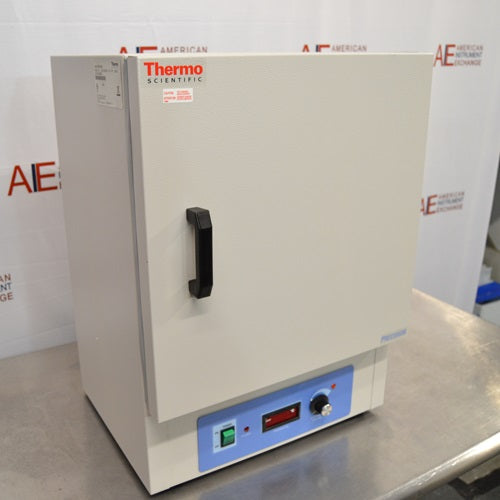 An angled side view of a closed Thermo Scientific PR305225M Precision mechanical convection oven resting on a stainless steel surface in front of an American Instrument Exchange backdrop, highlighting the left casing panel, serial label, front door handle, top Thermo Scientific branding, and bottom blue control panel.