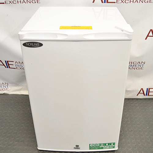 Slight high-angle front view of Norlake Scientific undercounter laboratory refrigerator with top yellow warning sticker and key lock