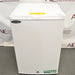 Slight high-angle front view of Norlake Scientific undercounter laboratory refrigerator with top yellow warning sticker and key lock