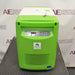 Front view of a Stirling ULT25NEU portable ultralow freezer on a textured surface with a vibrant green and white housing, control panel, and Stirling Ultracold logo.