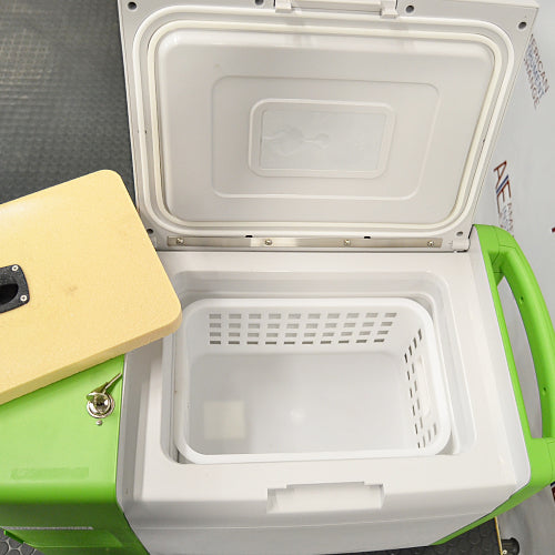 Stirling ULT25NEU portable ultralow freezer on a textured surface with a vibrant green and white housing, control panel, and Stirling Ultracold logo.