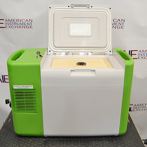 Stirling ULT25NEU portable ultralow freezer on a textured surface with a vibrant green and white housing, control panel, and Stirling Ultracold logo.