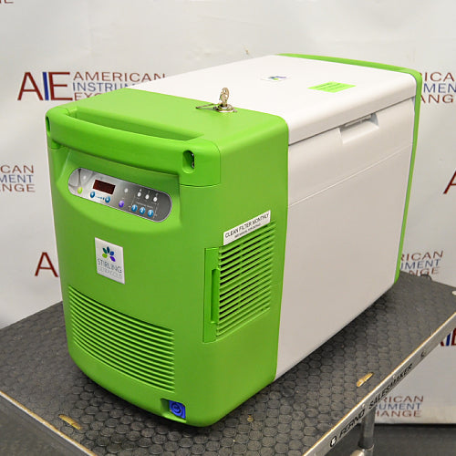 Front view of a Stirling ULT25NEU portable ultralow freezer on a textured surface with a vibrant green and white housing, control panel, and Stirling Ultracold logo.