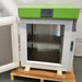 Three-quarter studio view of a Stirling Ultracold SU105UE undercounter ultralow freezer with the insulated door open, revealing the stainless steel interior chamber and a middle shelf.
