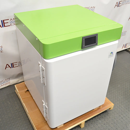 Three-quarter studio view of a Stirling Ultracold SU105UE undercounter ultralow freezer mounted on a wooden pallet, showing the heavy-duty door hinges and green top console.