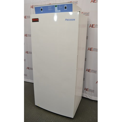 A white, upright Thermo Scientific Precision refrigerated incubator featuring a control panel on top, standing in front of an American Instrument Exchange backdrop.