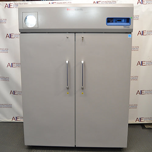 Front view of a closed Thermo Scientific TSX5005SA double solid-door laboratory refrigerator showing the handles and top digital control panel.