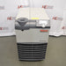 A front-facing view of the Thermo Scientific ThermoFlex 2500 recirculating chiller, model TF25 DW 200-230GL, featuring its beige and grey housing, digital control interface, and lower ventilation grille, positioned in front of an American Instrument Exchange backdrop.
