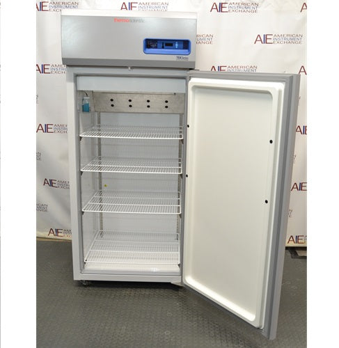 An open Thermo Scientific brand upright laboratory freezer with four wire shelves inside.