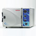 Tuttnauer 2340M Manual Tabletop Autoclave, silver in color, with control panel on the front. The device is designed for sterilization with a visible door for loading items.