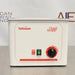A Tuttnauer 1-Gallon Ultrasonic Cleaner with Heater, featuring a white and red exterior, a control knob on the front, and the brand name visible on the top.