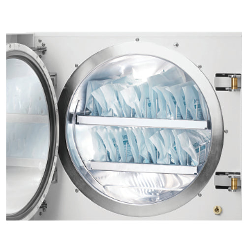 Open chamber view of a Tuttnauer D-Line 3870EA 85L autoclave loaded with sterilization pouches in tray racks.