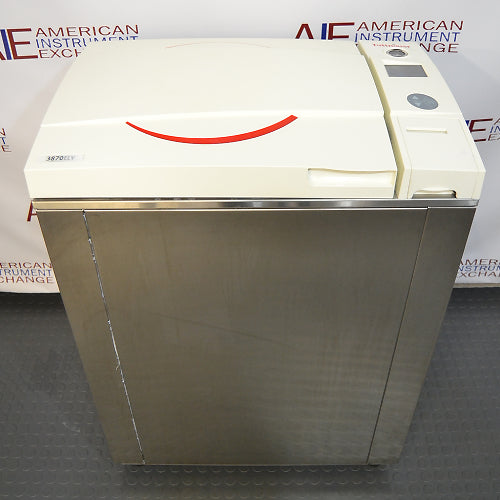Tuttnauer vertical autoclave, stainless steel, with a white control panel on top, branded with Tuttnauer logo.