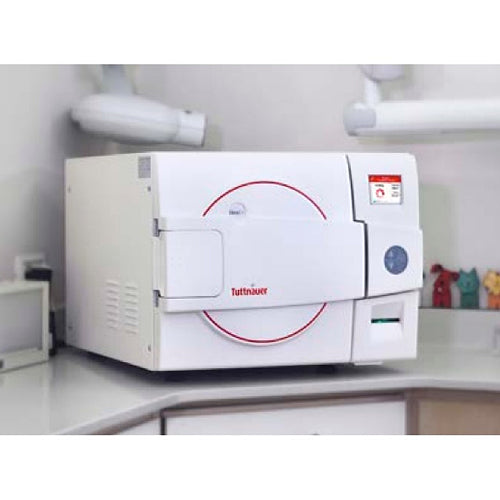 Angled view of a Tuttnauer D-Line tabletop autoclave placed on a countertop in a clinical setting