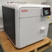 Angled view of a closed Tuttnauer T-Edge 11B tabletop autoclave showing the side ventilation grille, front door handle, and digital touchscreen.