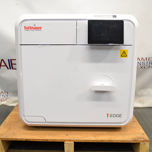 Front view of a closed Tuttnauer T-Edge 11B Class B tabletop autoclave showing the digital touchscreen display and door handle.