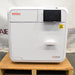 Front view of a closed Tuttnauer T-Edge 11B Class B tabletop autoclave showing the digital touchscreen display and door handle.