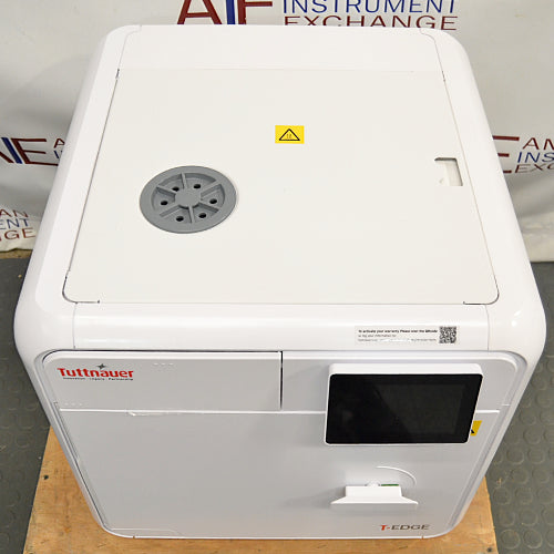 Top-down view of a closed Tuttnauer T-Edge autoclave showing the top access panel, water fill port, and front digital touchscreen.