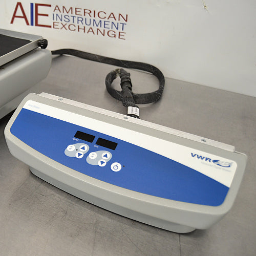 Close-up studio view of the standalone digital control console for the VWR Advanced Dura-Shaker, featuring dual LED displays, arrow control pads, a power button, and a connecting cable on a metallic surface