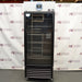 Straight-on studio view of a VWR HCLS-26 upright laboratory refrigerator standing on casters against a branded backdrop, featuring a full-length glass door, top-mounted digital control panel, and lower ventilation louvers