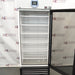 Studio view of the VWR HCLS-26 upright laboratory refrigerator with its glass door swung open, showcasing the interior cabinet fitted with multiple white wire shelves, top digital temperature controller, and louvered base