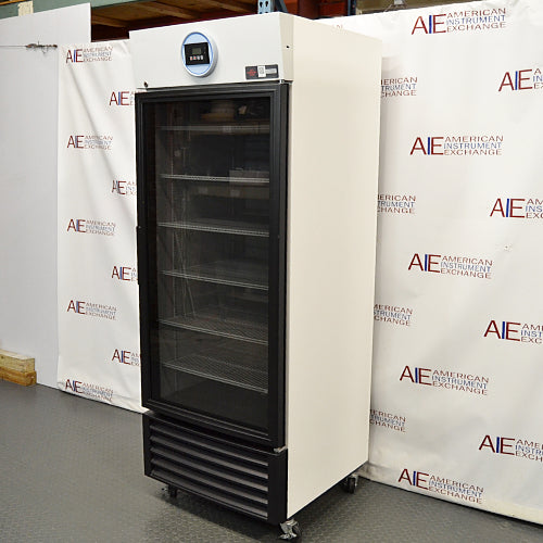 Three-quarter right-angled studio view of a VWR HCLS-26 upright laboratory refrigerator standing on casters against a branded backdrop, displaying its white exterior housing, black-framed glass door, top digital display unit, and lower ventilation grille