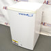 A white VWR undercounter laboratory refrigerator with a blue logo, standing on a floor with 'CAUTION' and 'SERVICE内部使用禁止' stickers on it.