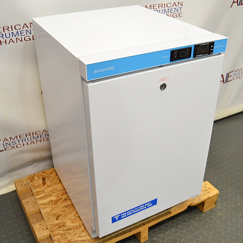 Front angled perspective view of an AccuCold ACR45L undercounter healthcare all-refrigerator on a wooden pallet, showcasing its white cabinet housing, solid locking door, and upper blue control console with digital displays