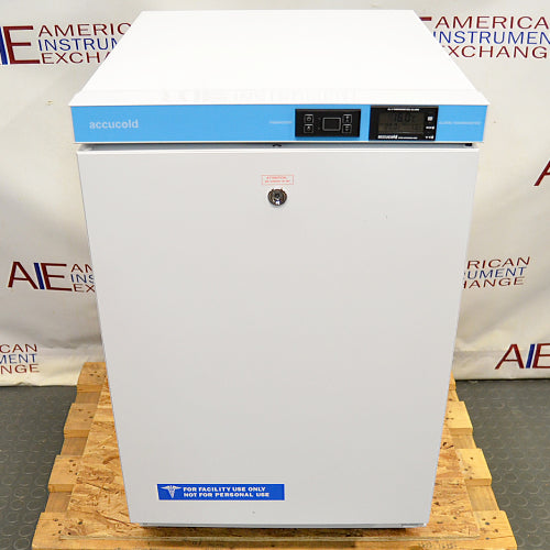 Front eye-level view of an AccuCold ACR45L undercounter healthcare all-refrigerator on a wooden pallet, featuring a white exterior housing, a closed locking door with a facility use label, and an upper blue control panel with digital displays