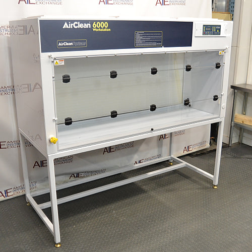 Right three-quarter angle product view of an AirClean 6000 HLF horizontal laminar flow clean bench, showcasing its white body, dark blue upper console, digital control panel, clear side panels, and metal support stand