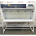 Straight-on eye-level product view of an AirClean 6000 HLF horizontal laminar flow clean bench, featuring its white structure, dark blue front upper panel, digital control interface, clear side panels, and metal support stand