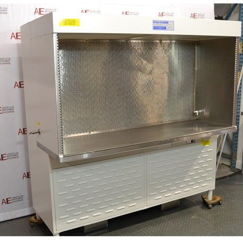 Left angled perspective view of Baker Edgegard EG6320 laminar flow clean bench showing outer enclosure side wall, interior stainless steel benchtop, rear airflow screen, and lower louvered support base