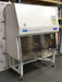 Front angled perspective view of a Baker SterilGARD e3 SG504 biosafety cabinet mounted on a locking caster stand, featuring a white exterior housing, sloped front sash with a stainless steel work zone, and blue brand graphics