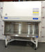 Front eye-level view of a Baker SterilGARD e3 SG504 biosafety cabinet on a mobile locking stand, showcasing its white cabinet exterior, sloped top section with instruction placard, and a spacious stainless steel work area enclosed by a clear sash