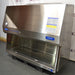 Right three-quarter angle product view of a Baker SterilGARD e3 SG604 stainless steel biosafety cabinet, featuring its right side panel, information placard, angled canopy, and stainless steel interior workspace