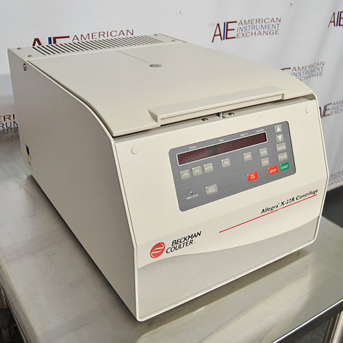 Front angled perspective view of a Beckman Coulter Allegra X-22R refrigerated centrifuge on a stainless steel surface, featuring its beige housing, closed lid, and digital control panel