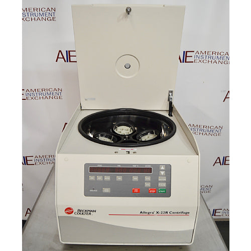 Front eye-level view of a Beckman Coulter Allegra X-22R refrigerated centrifuge with its top lid swung open, revealing the interior rotor chamber loaded with bucket adapters and the front digital control panel