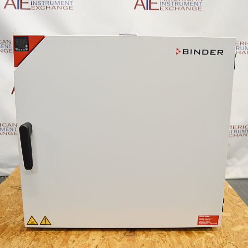 Front product view of a Binder FD-S 115 mechanical convection oven, highlighting its solid white exterior door, black door handle, red top-left control panel housing digital displays, and safety warning labels