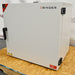 Right three-quarter angle product view of a Binder FD-S 115 mechanical convection oven, showcasing the white side housing panel, heavy-duty door hinges, and brand logo on a wooden shipping pallet