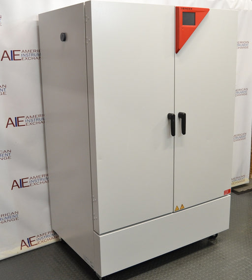Angled perspective view of a Binder KMF 720 constant climate and humidity test chamber featuring closed solid doors, vertical handles, and its characteristic red control panel accent on the top right
