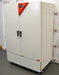 Left angled perspective view of a Binder KMF 720 constant climate and humidity test chamber showcasing its left side panel, closed double doors with handles, and caster-mounted base