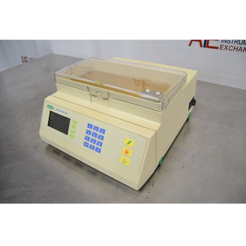 Side perspective view of the Bio-Rad PROTEAN IEF Cell unit resting on a stainless steel work surface, showing the beige housing, side power switch, closed transparent lid, and front control keypad