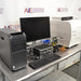 Comprehensive front angled view of a BioTek Cytation 5 cell imaging multimode reader system on a stainless steel counter, featuring an HP Z workstation tower, monitor, keyboard, mouse, accessory cases, and gas controller module