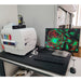 Front eye-level view of a BioTek Cytation 5 cell imaging multimode reader set up on a laboratory desk with an attached monitor displaying a fluorescent cell image, keyboard, mouse, and control module