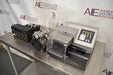 Angled perspective view of a BioTek ELx405UV Select microplate washer setup featuring the main washer unit, vacuum pump, valve module, and collection bottle on a stainless steel surface
