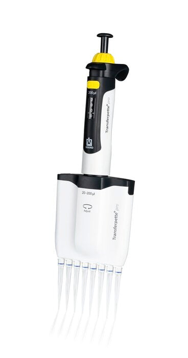 BRANDTECH Transferpette pro 8-channel multichannel pipette, 20 to 200 uL volume range, white handle with yellow accent plunger and clear pipette tips attached