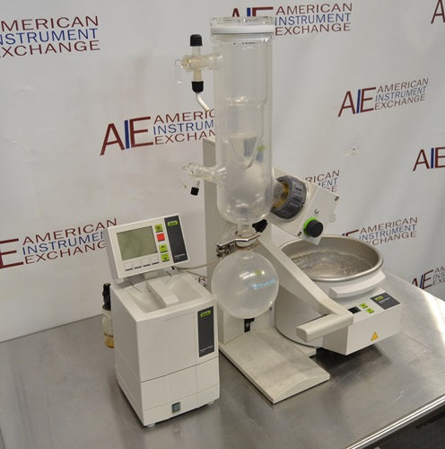 Angled perspective view of Buchi R-100 rotary evaporator system showing glass condenser assembly, receiving flask, heating bath, and digital controller module